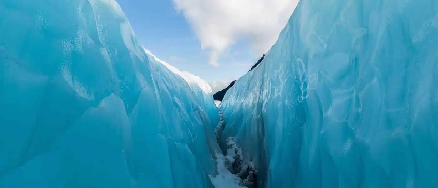 Deep blue crevasse opening in the ice of Franz Josef Glacier