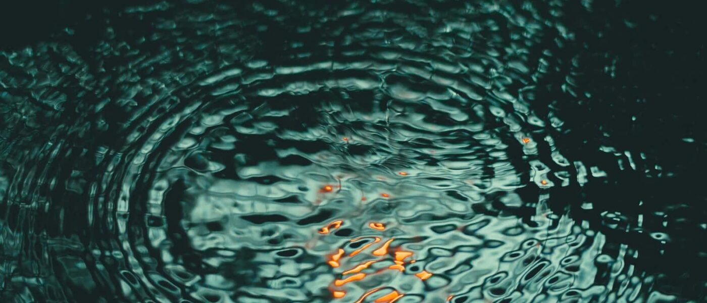 Couple relaxing in a secluded warm pool in the rainforest