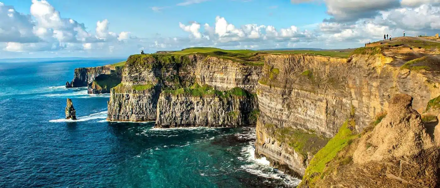Layered cliff faces and churning Atlantic waves at the Cliffs of Moher