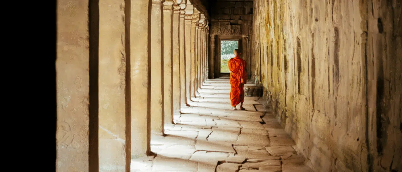Monks in saffron robes with vessels of water