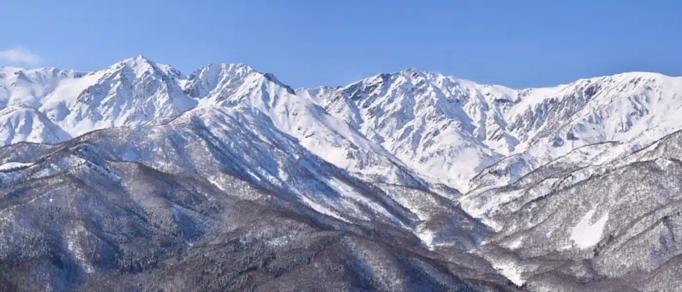 Small shrine half-buried in snow on a Hakuba ridgeline
