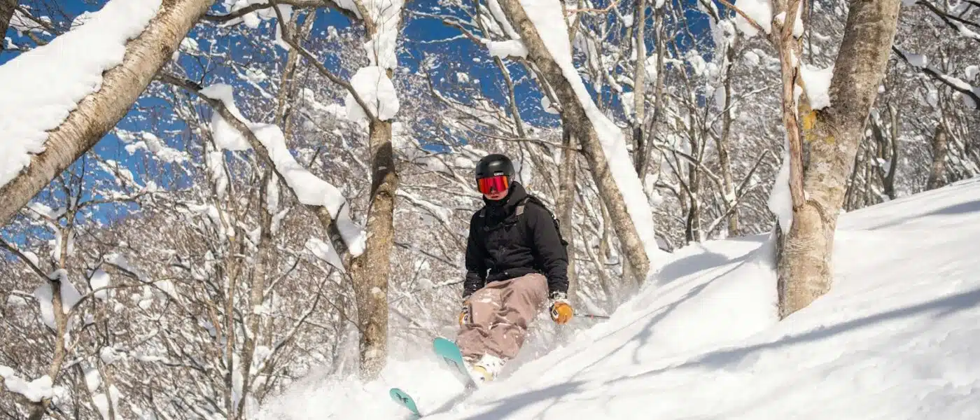 Guide examining the snowpack on an exposed slope above Hakuba