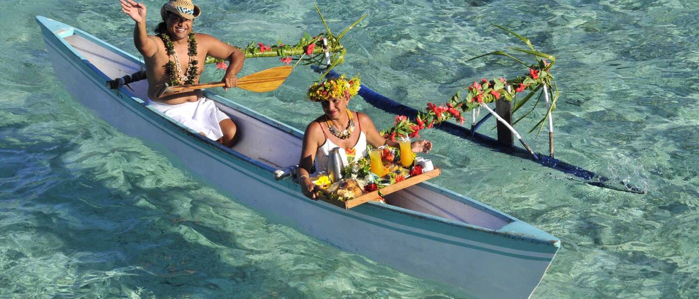 Traditional va'a outrigger canoe pulled up on a Bora Bora beach
