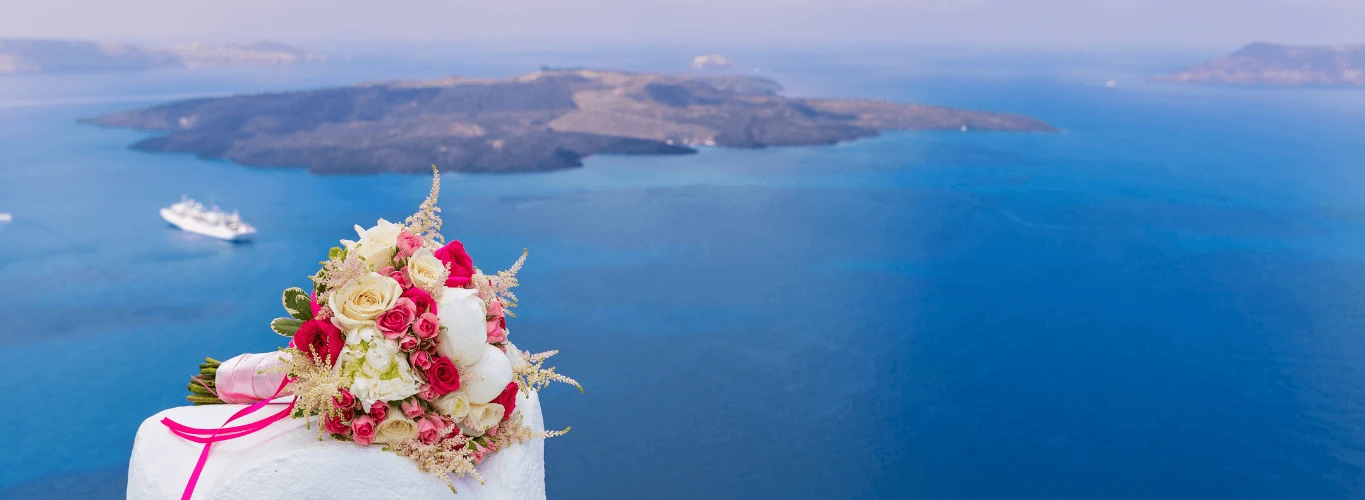 gay weddings in Greece - santorini caldera view with marriage bouquet