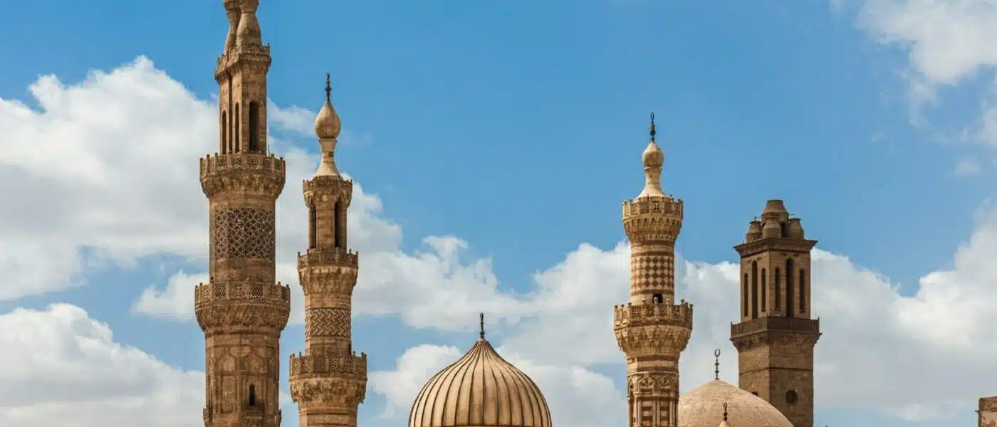 Historic Cairo skyline with mosque minarets at golden hour