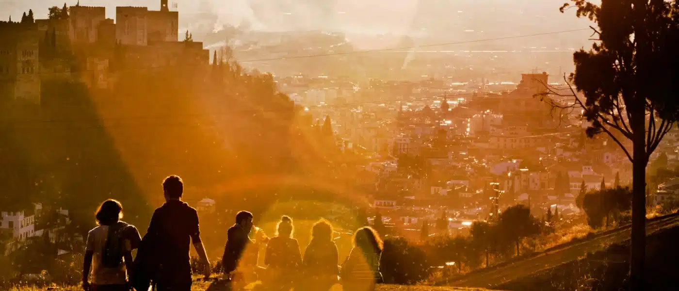 group of people sitting on grass field during daytime - granada