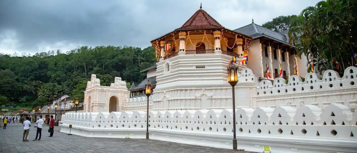 Monks carrying offerings during a daily ritual at the Temple of the Tooth