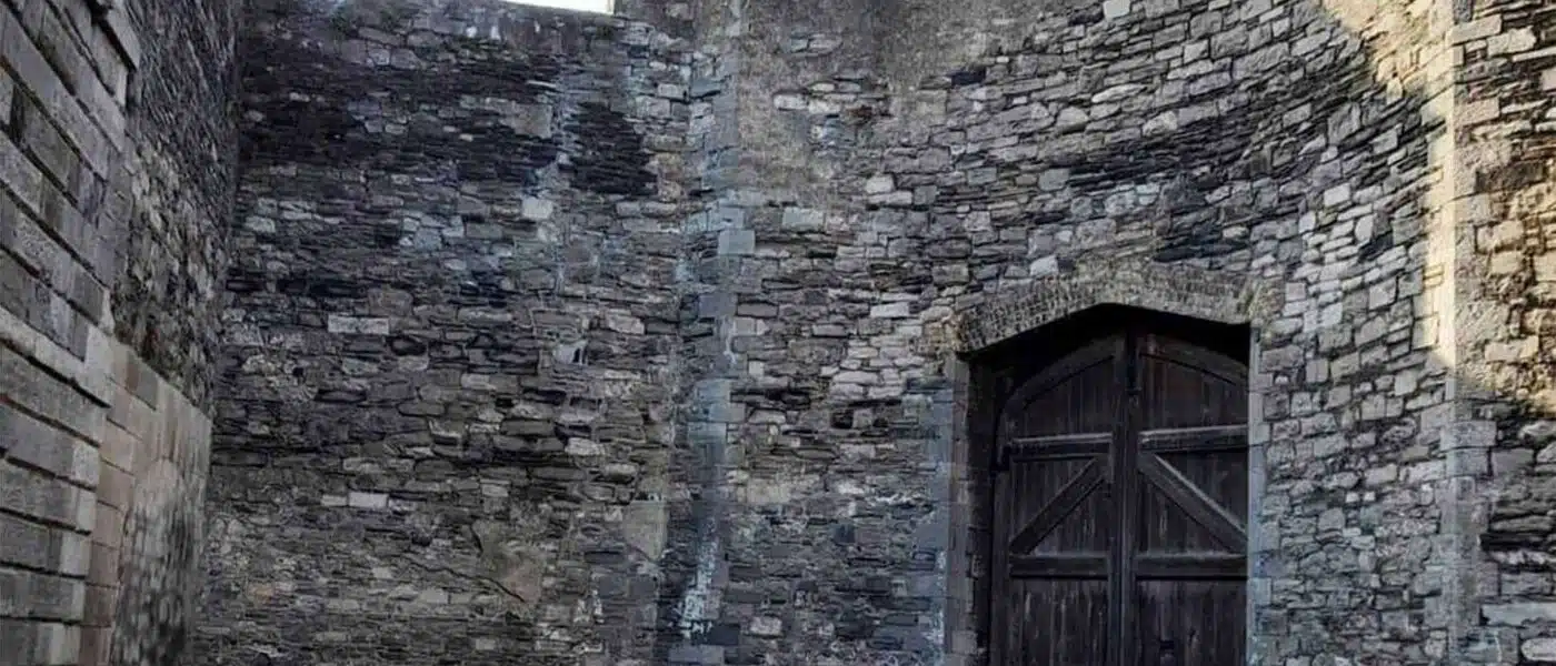 Empty Stonebreakers' Yard at Kilmainham Gaol with its memorial cross