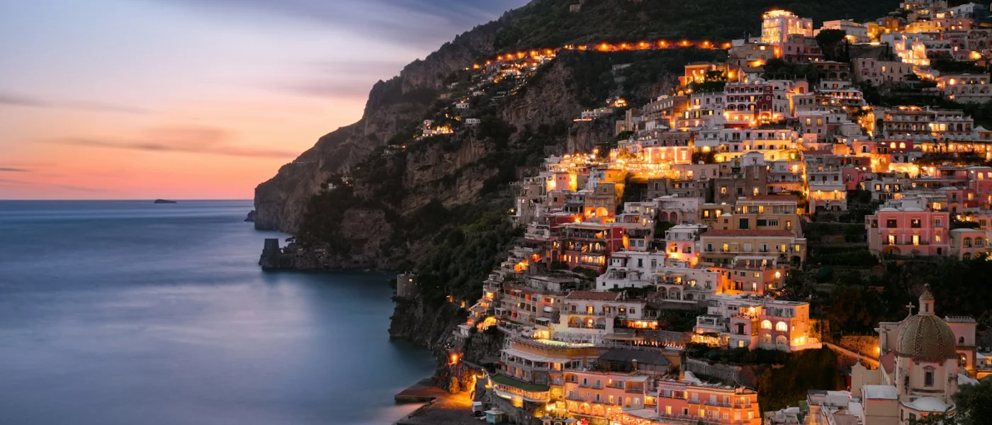 Long exposure of the village of Positano illuminated on the Amalfi coast at night Villa Lysis Amalfi Coast
