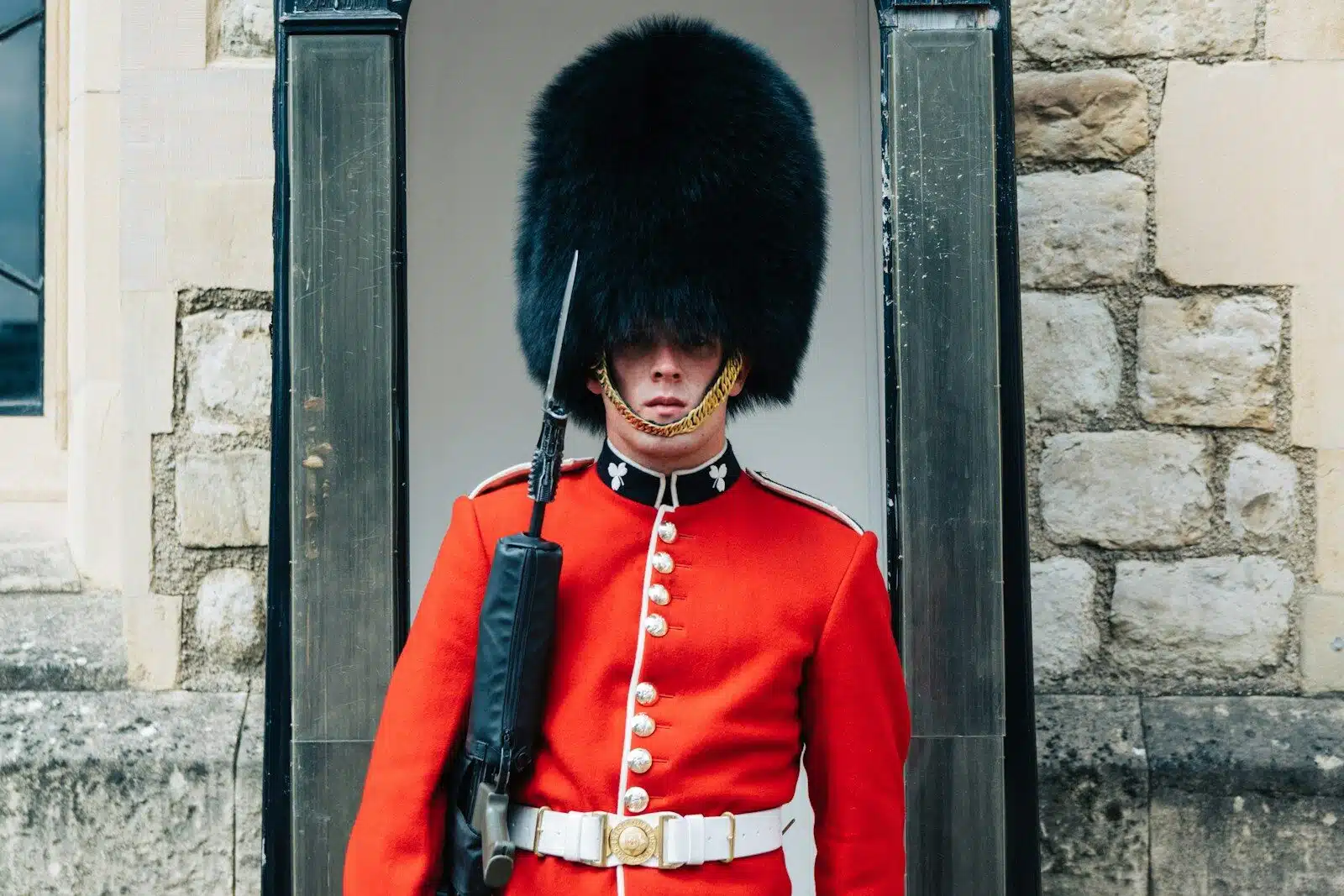 guard standing near brown wall