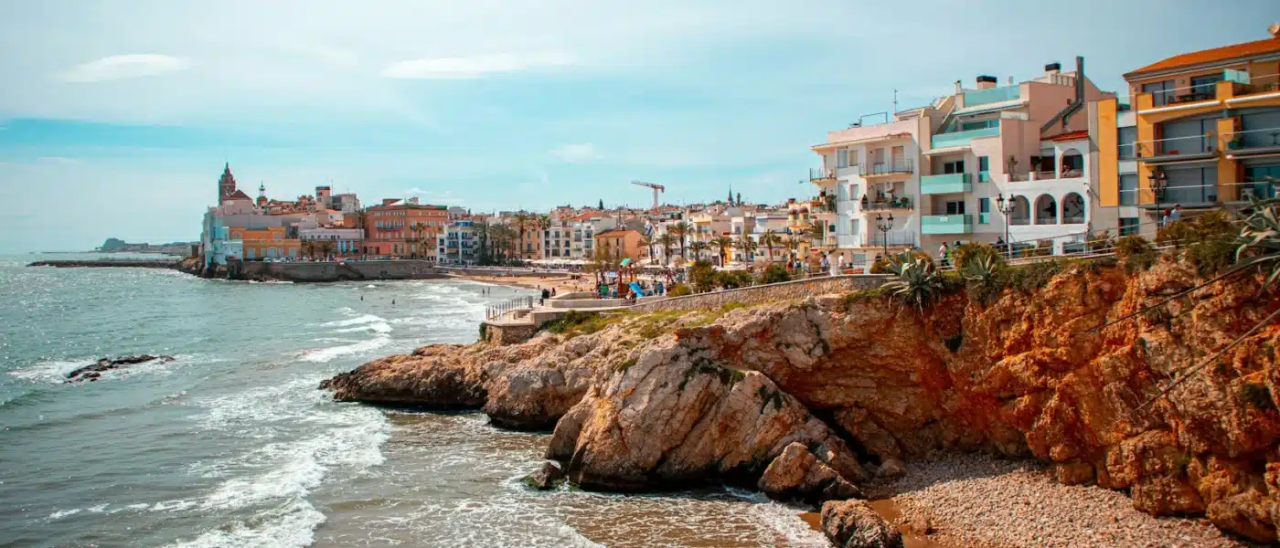 people on beach near buildings during daytime - Sitges