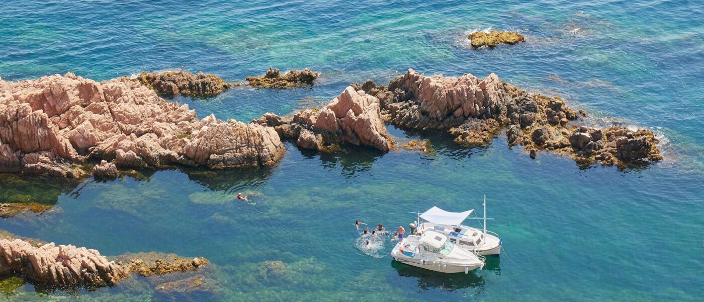 Pale cliffs and dark inlets of the Costa Brava seen from a boat