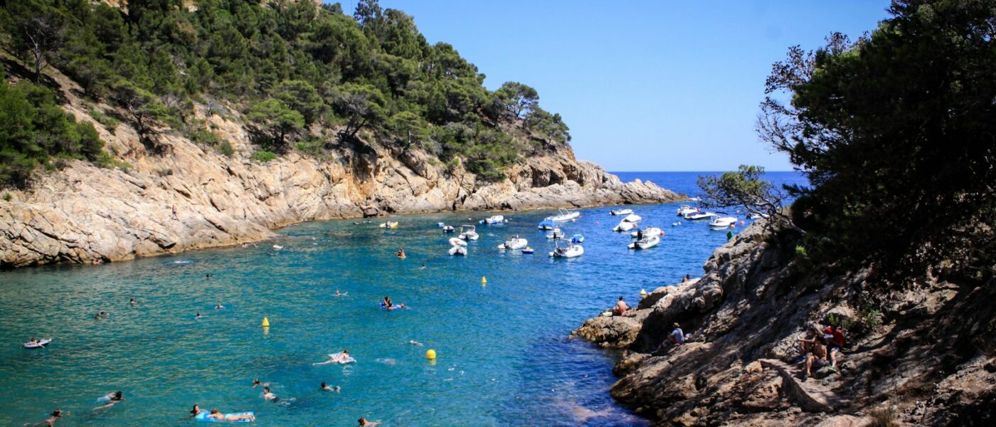 Boat heading home along the Costa Brava in late afternoon light