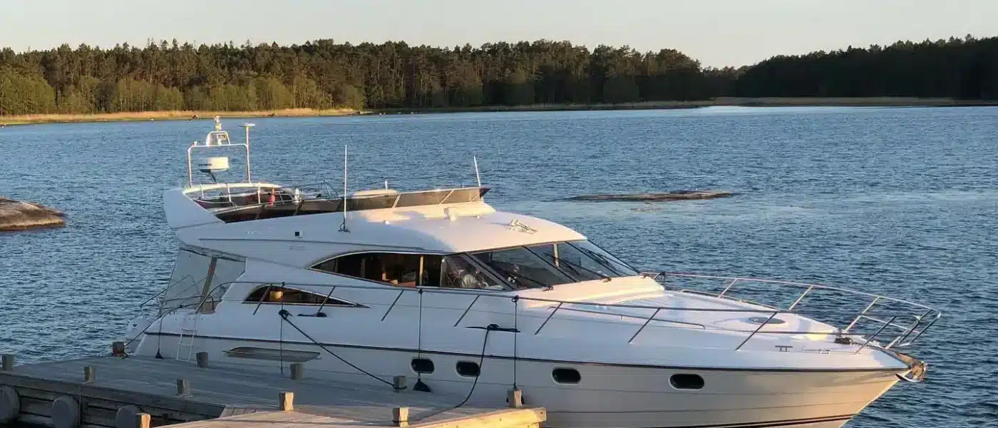 Yacht anchored in a quiet cove between rocky shorelines