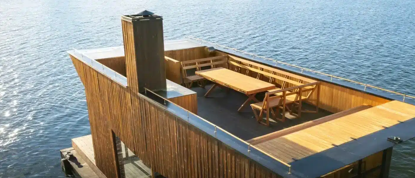 Two bathers resting on warm rocks between sauna rounds