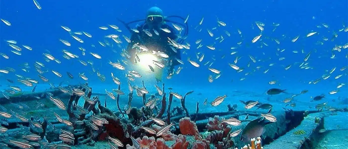 Private dive guide leading a pair of divers around the Kayali wreck