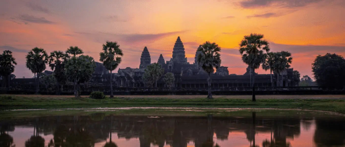Angkor Wat's towers reflected in a pond at dawn