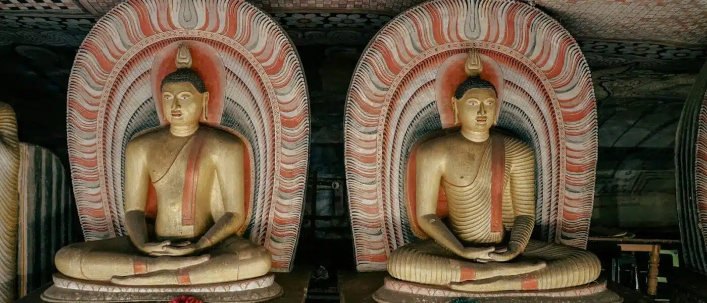 Whitewashed entrance to the Dambulla cave temples beneath the rock