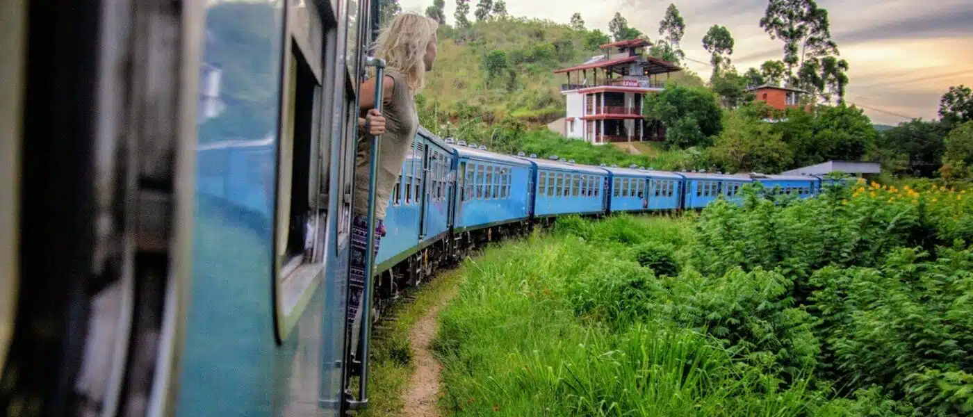 Hill country railway line winding through green tea estates