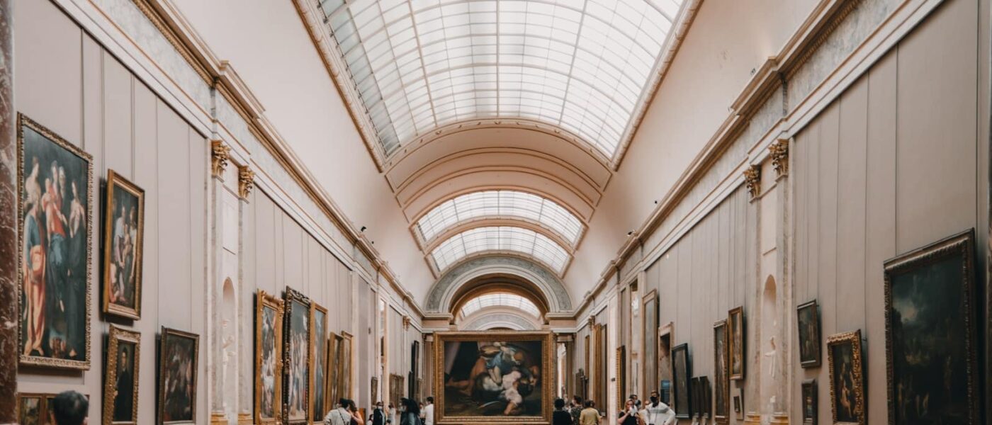 Licensed guide with a small group in a Louvre gallery