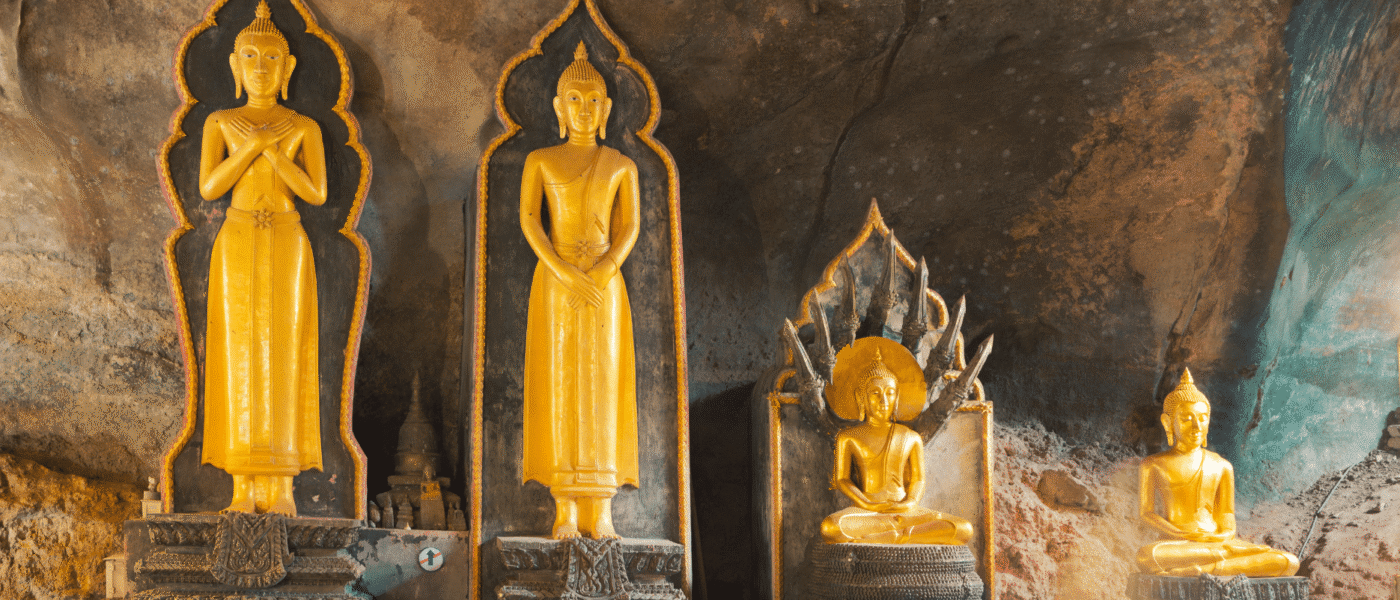 Offerings at small shrines along the walls of the cave temple