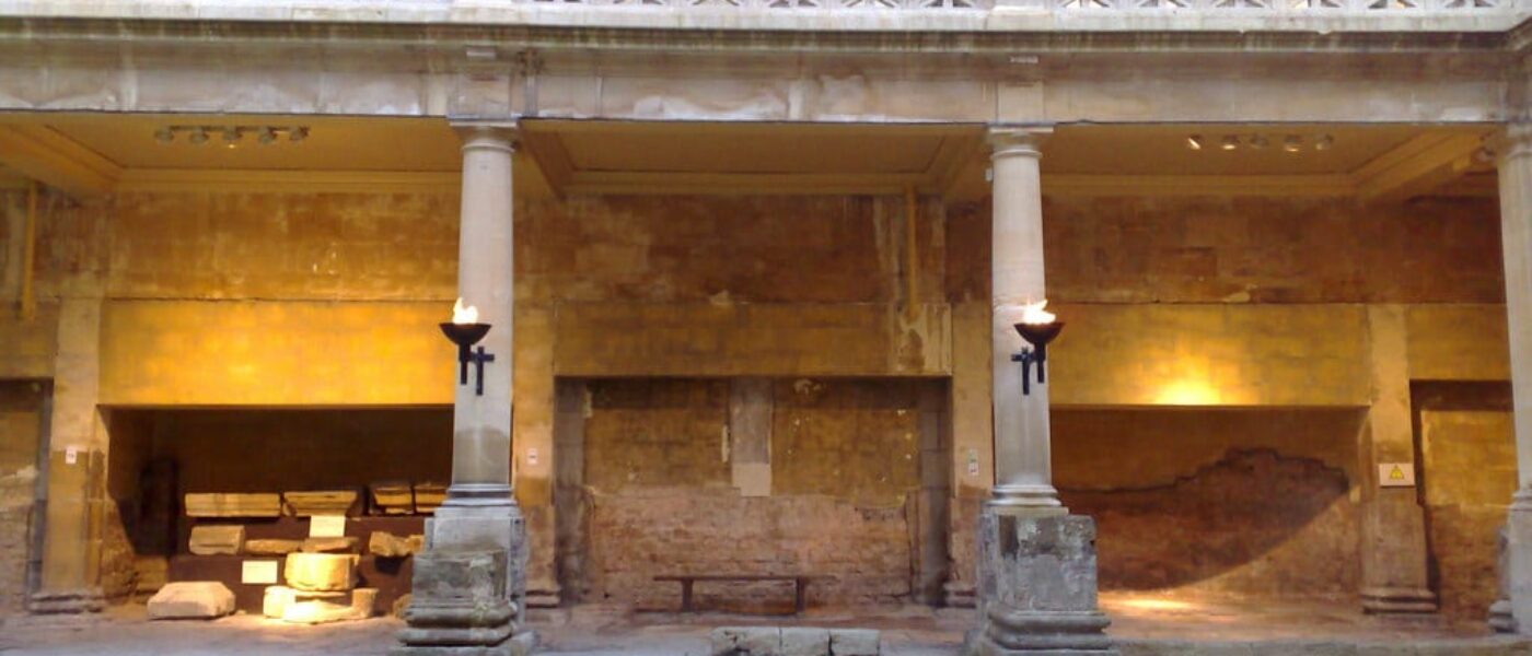 Private guide pointing out inscriptions to visitors at the Roman Baths