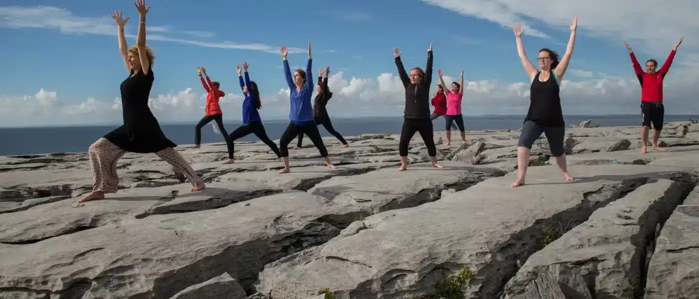 Guide leading a short meditation on a Burren ledge