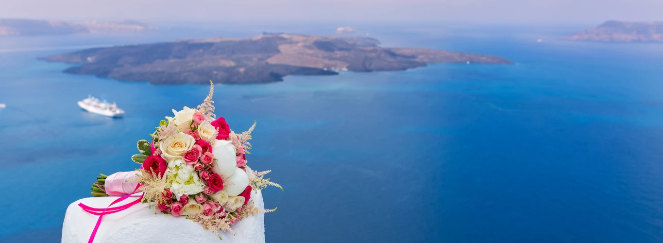 gay weddings in Greece - santorini caldera view with marriage bouquet